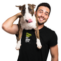 Man holding a dog with a black shirt with phrasing 