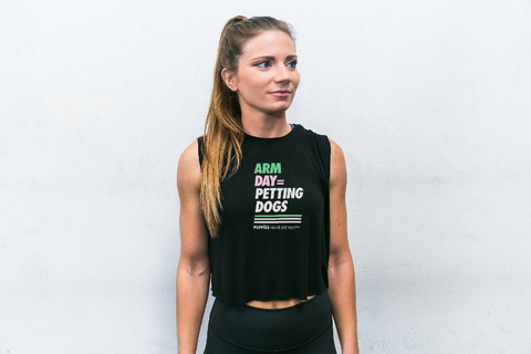 WOMAN WEARING BLACK SLEEVELESS TANK WITH ARM DAY PETTING MORE DOGS